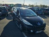 a black car parked in a parking lot next to other cars