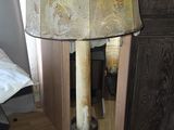 a lamp that is sitting on the floor in front of a mirror