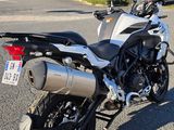 a motorcycle parked in a parking lot with a building in the background