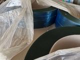 many rolls of tape sitting on a table in a warehouse