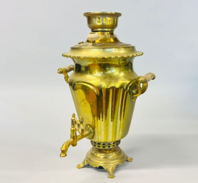 a gold vase that is sitting on a table