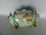 a white bowl with flowers on it on a table