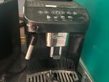 a black coffee maker sitting on a counter next to a black coffee maker