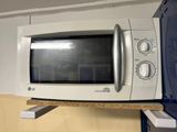 a microwave that is sitting on a shelf in the kitchen