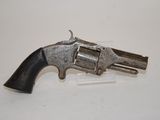 a gun that is on display on a white surface