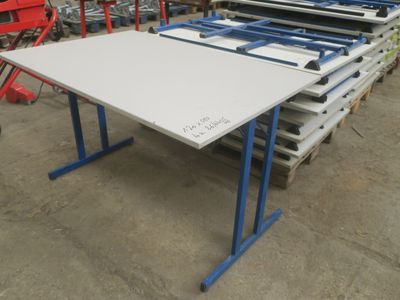une table blanche aux pieds bleus dans un entrepôt