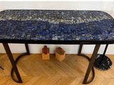 a table with a blue mosaic tile top on it
