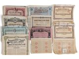 several old paper certificates are stacked on top of each other