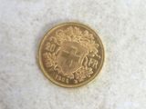 a gold coin with a coat of arms on it