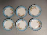 six blue and white plates with floral designs on them on a table