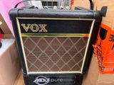 a black amp sitting on top of a cardboard box