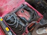 a red tool box with tools in it on the floor