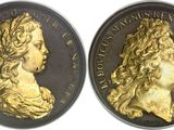 a close up of a gold coin with a woman ' s face