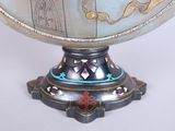 a silver vase with a blue and gold decoration on it