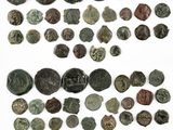 a group of ancient roman coins on a white surface