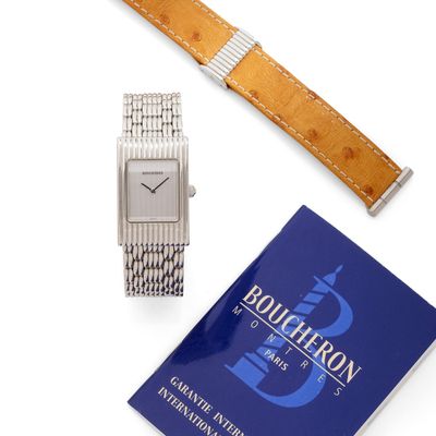 an image of a watch and a book on a white surface