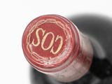 a close up of a wine bottle with a red label on it