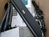 a computer in a cardboard box with wires and cords