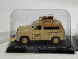 a toy truck with luggage on top of it in a glass case