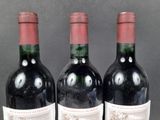 three bottles of wine sitting next to each other on a table