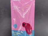 a pink packet with a red heart on it sitting on a table