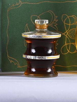 a bottle of liquor sitting on a table next to a clock