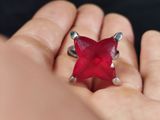 a person holding a ring with a red star on it