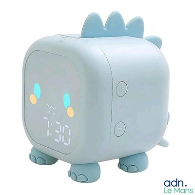a blue alarm clock with a dinosaur design on it