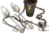 a lot of silver spoons and spoon spoons on the table