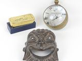a clock and a bottle opener sitting next to each other