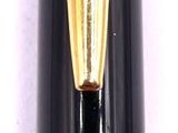 a black and gold fountain pen sitting on top of a white surface
