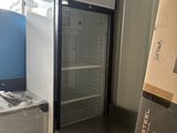 un réfrigérateur et un congélateur dans une pièce où se trouvent des cartons