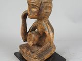 an image of a wooden statue of a man with a hat on his head