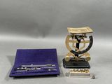 a silver and gold object with a purple case