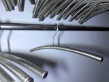 a bunch of metal tubes hanging on a rack
