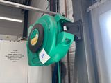 a green machine that is hanging from the ceiling