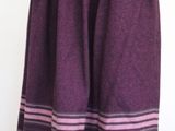 a purple skirt with pink stripes on it on a mannequin stand