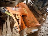 an orange machine that is sitting on the ground