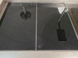 two sinks in the bathroom with a drain on the floor