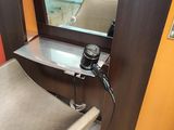a hair dryer sitting on a chair in front of a mirror