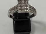 an image of a diamond ring on a black stand