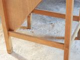 a wooden table with a drawer underneath it on the floor