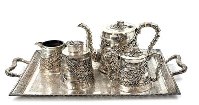 a silver tray with a silver tea set on it