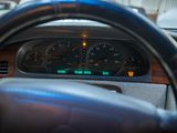 a car dashboard with a speedometer and a steering wheel