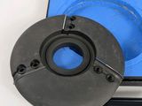 un gros plan sur un objet métallique avec une boîte bleue en arrière-plan