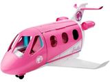 un petit avion rose posé sur une surface blanche