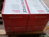 two boxes of office supplies on a pallet in a warehouse