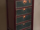 an image of a green and brown chest of drawers