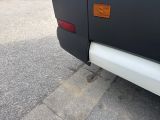 a black bus parked on the side of the road