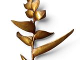 brass flower on a stem with leaves on a white background